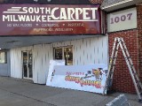 South Milwaukee Carpets sign on marquee with Board Game Barrister sign waiting to be installed